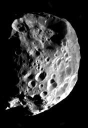Phoebe's true nature is revealed in startling clarity in this mosaic of two images from NASA's Cassini spacecraft flyby on June 11, 2004.